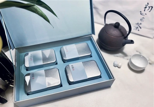The packaging opens into four individual tea compartments.